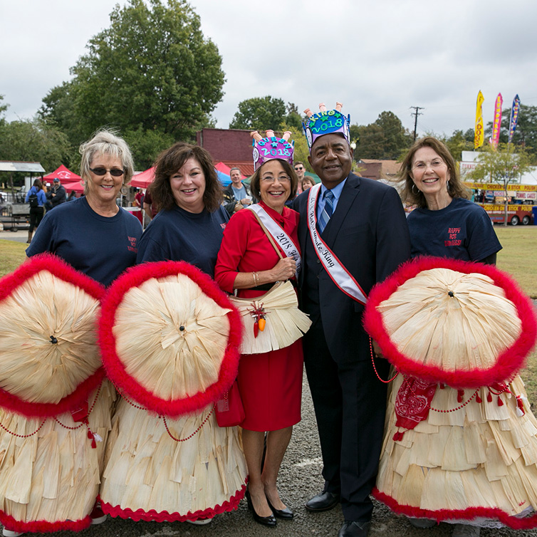 A man and three women dressed up in costumes for the tamale festival